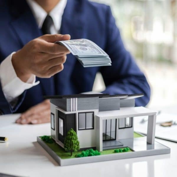 https://allquestmortgage.com/wp-content/uploads/2026/01/real-estate-businessman-giving-money-for-buying-a-house-600x600-1.jpg